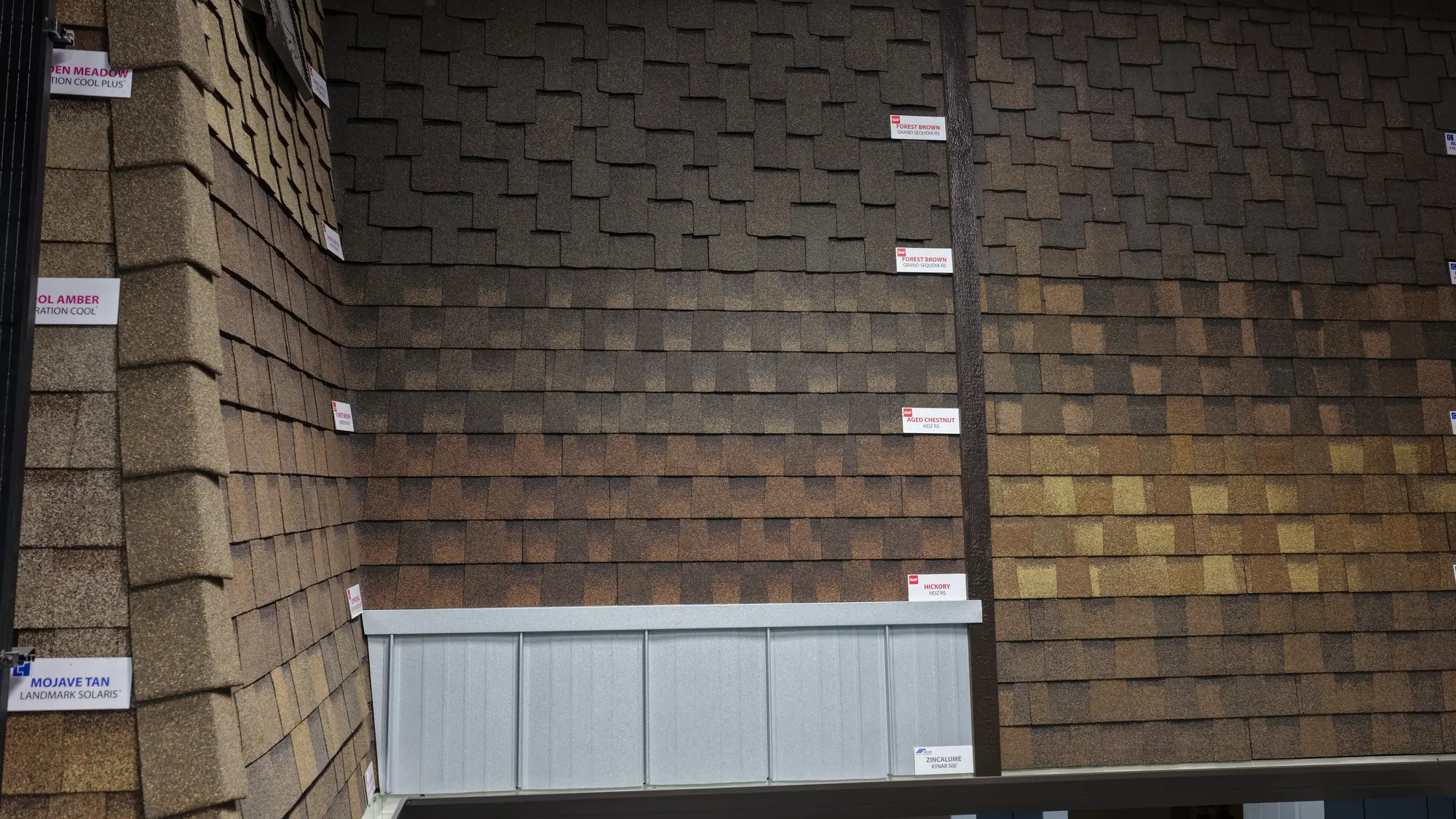 A wall of cedar-tone shake and lap siding samples at the Straight Line showroom