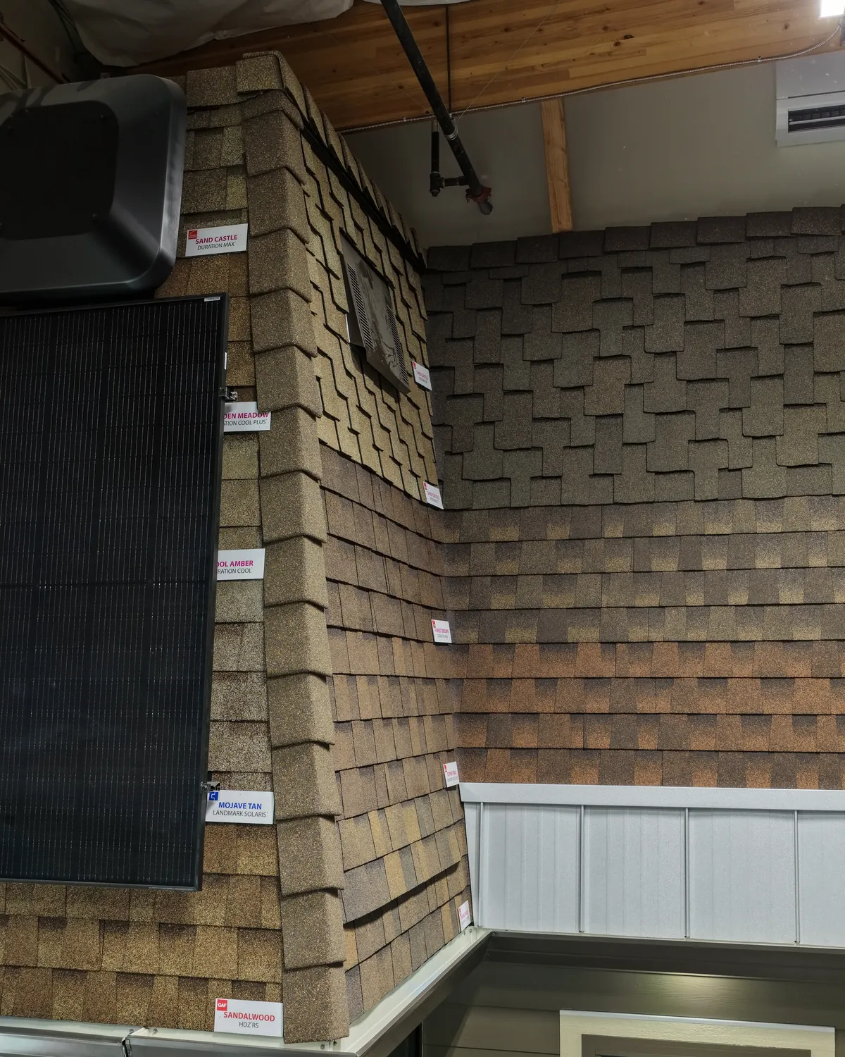 Shake and lap siding running across a building corner beside a window