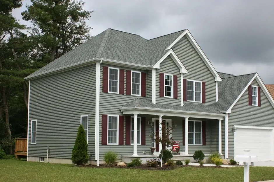 A two-story home with new windows across the front elevation