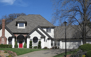 dark gray composition shingles on a white home