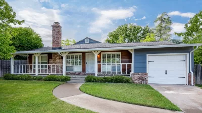 Ranch Style Home With Blue siding and Brick base