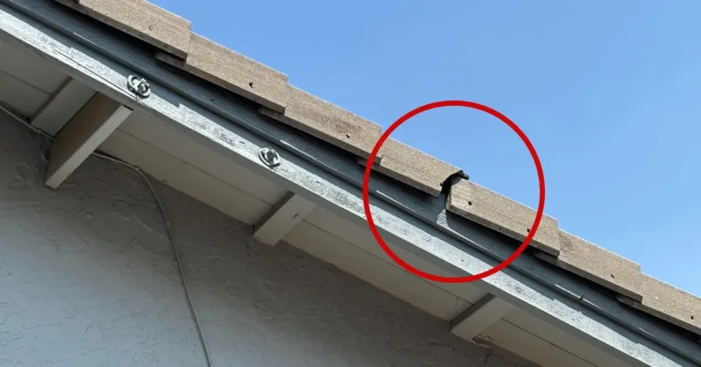 Broken wooden shake on edge needing roof repair in Sacramento