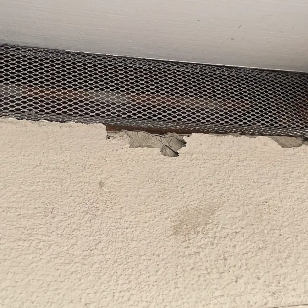 Stucco repair where exterior wall meets roof