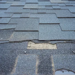 Broken and torn shingles in need of roof repair in Sacramento