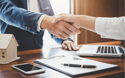 Homeowner shaking hands with a businessman.